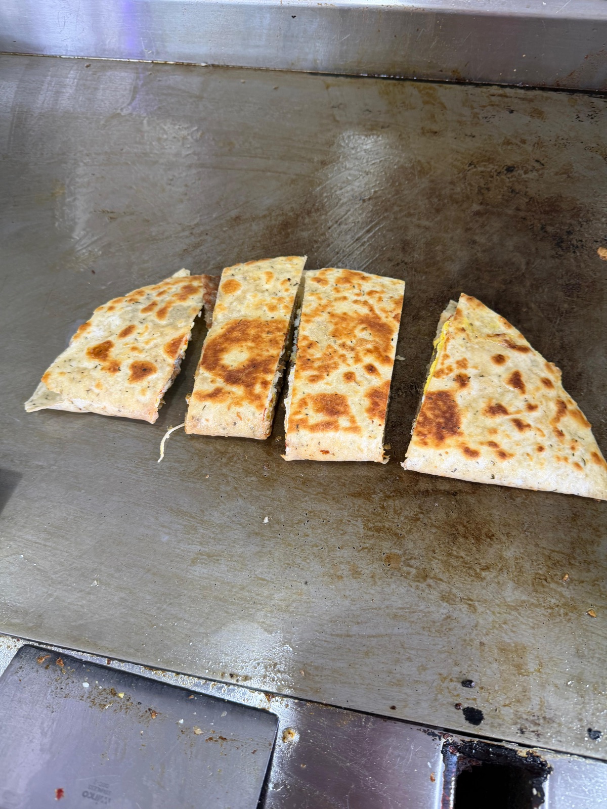 Turkish gözleme flatbread toasted on the griddle